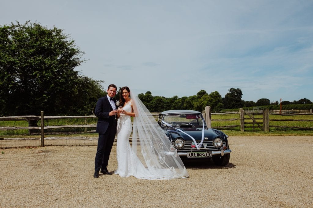 bride and groom at gayness park with vintage car