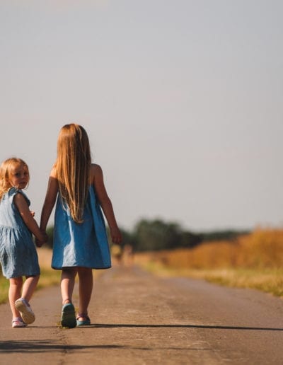 two girls walking down the road