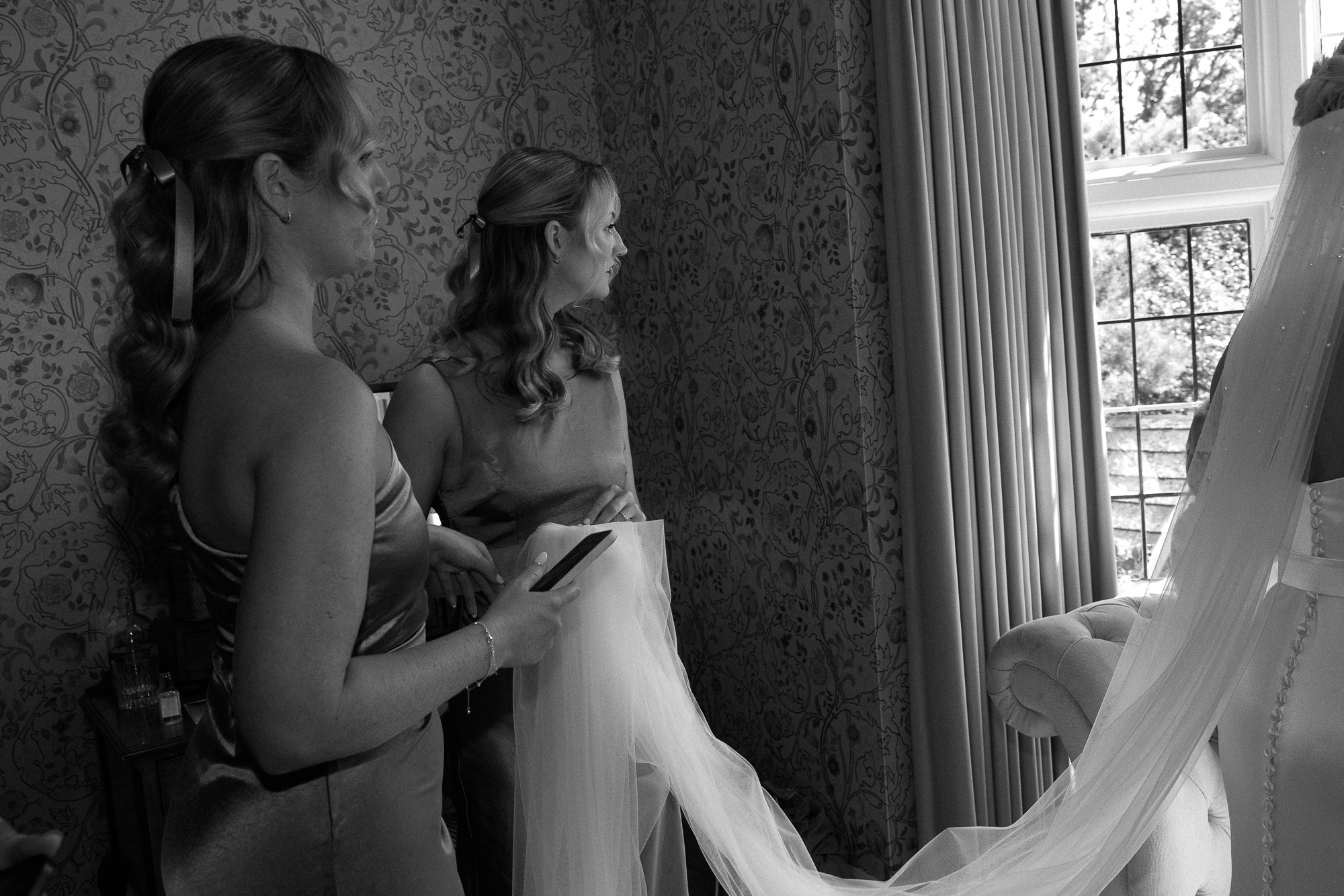 NATHALIE DELENTE PHOTOGRAPHY-18 bridesmaids looking out of the window taken by london wedding photographer